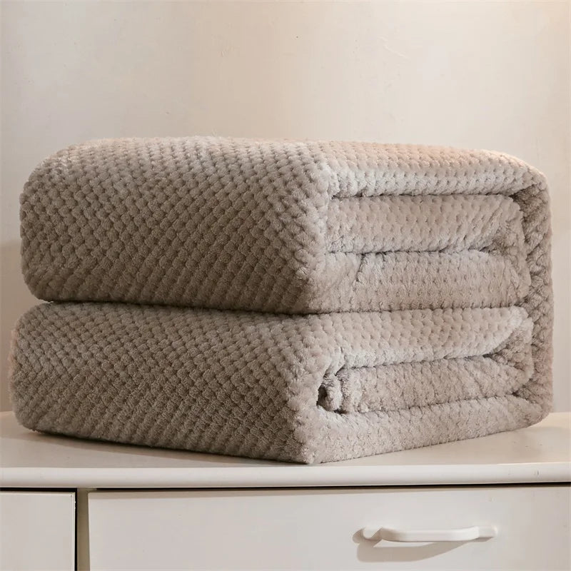 Folded beige plush fleece blanket